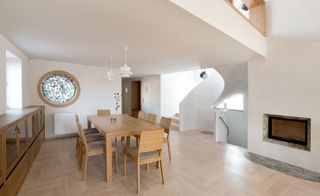 The open plan living area with a decorative stained glass window
