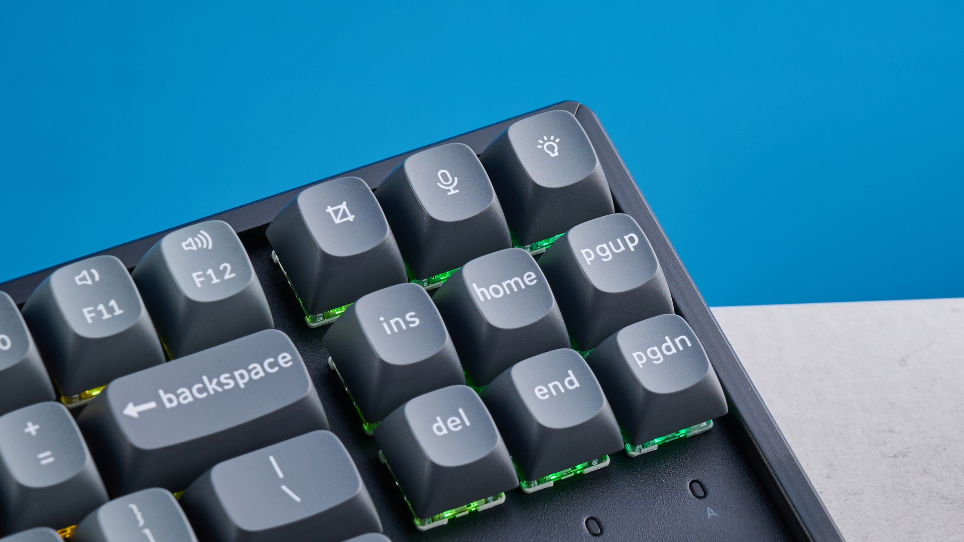 Keychron K8 Max mechanical keyboard in gray photographed on a blue background