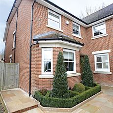 house exterior with brick wall and white window