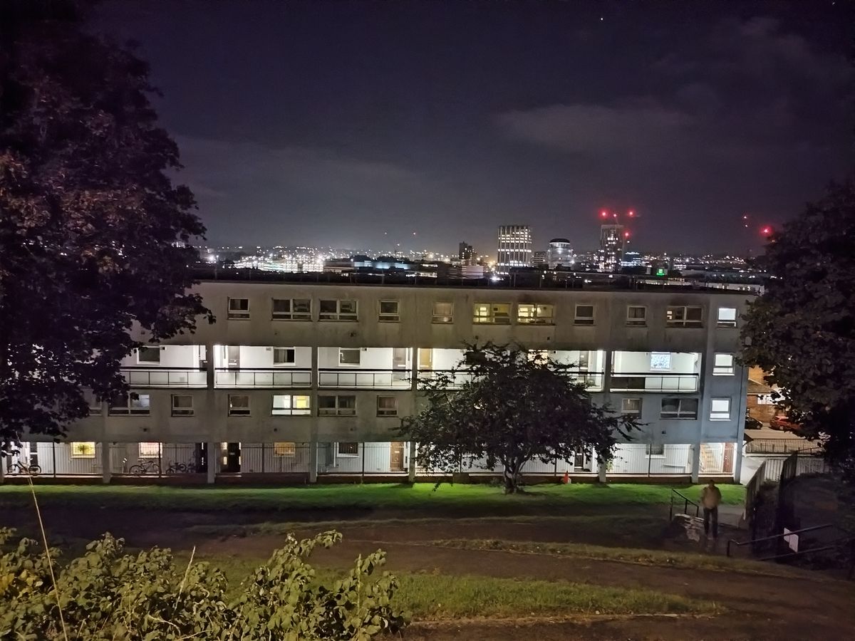 A photo of a block of flats at night