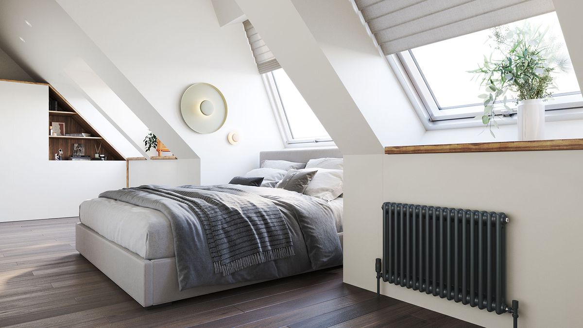 loft conversion bedroom with engineered wood flooring and grey column radiator