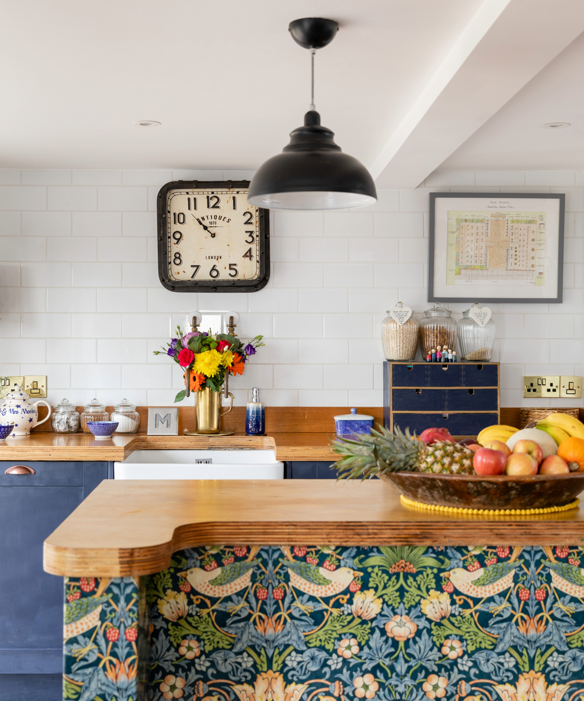 Blue kitchen with statement wallpaper island