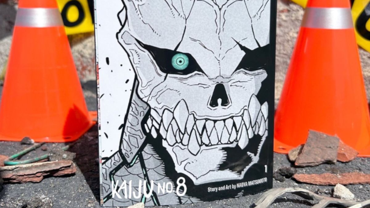 Kaiju No. 8 variant cover volume 1 on a street with bollards and warning tape behind it