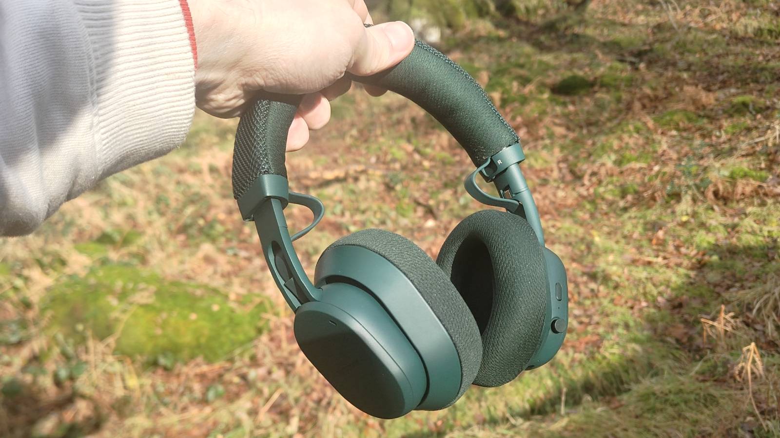 The Fairphone Fairbuds XL 2025 in a man's hand.