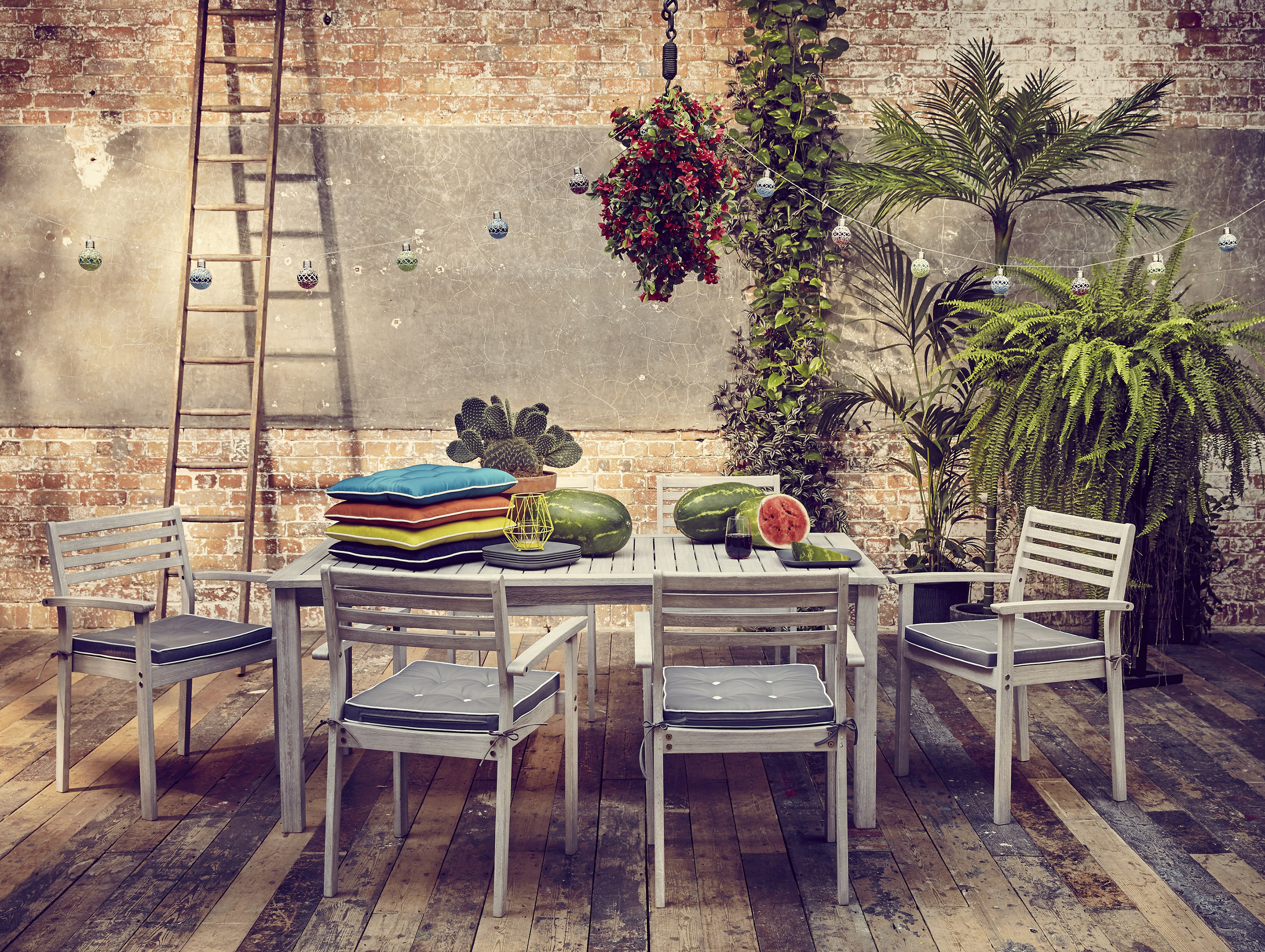 Rustic and industrial style decking with plenty of plants and vertical ladder