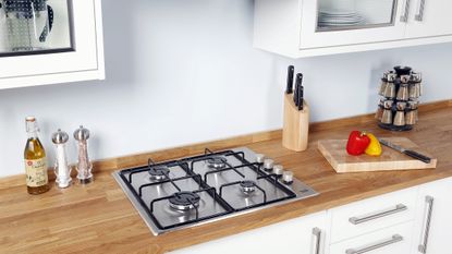 Best gas hob 2022, image shows gas hob in a wooden kitchen countertop
