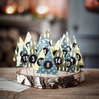 Homemade advent calendar with trees on cocktail sticks