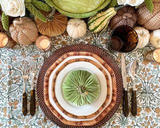 Thanksgiving decor ideas, decorated table with green tableware, decor and pumpkins