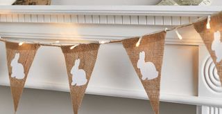 hessian bunny bunting hanging across a mantelpiece to show an effective Easter mantel decor idea