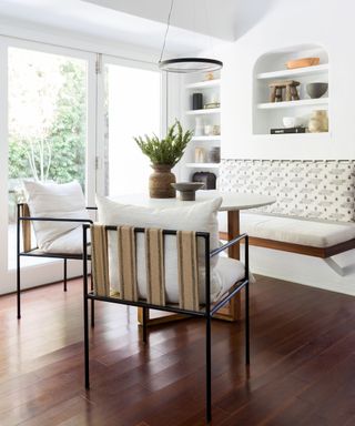 White dining room with wood floor