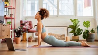 Woman practicing yoga at home