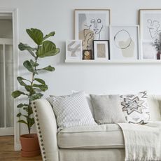 white living room with a picture ledge and wall art