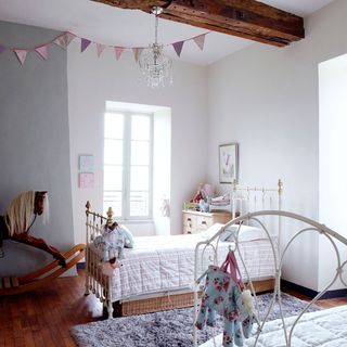 bedroom with white wall and wooden floor and white window and beam