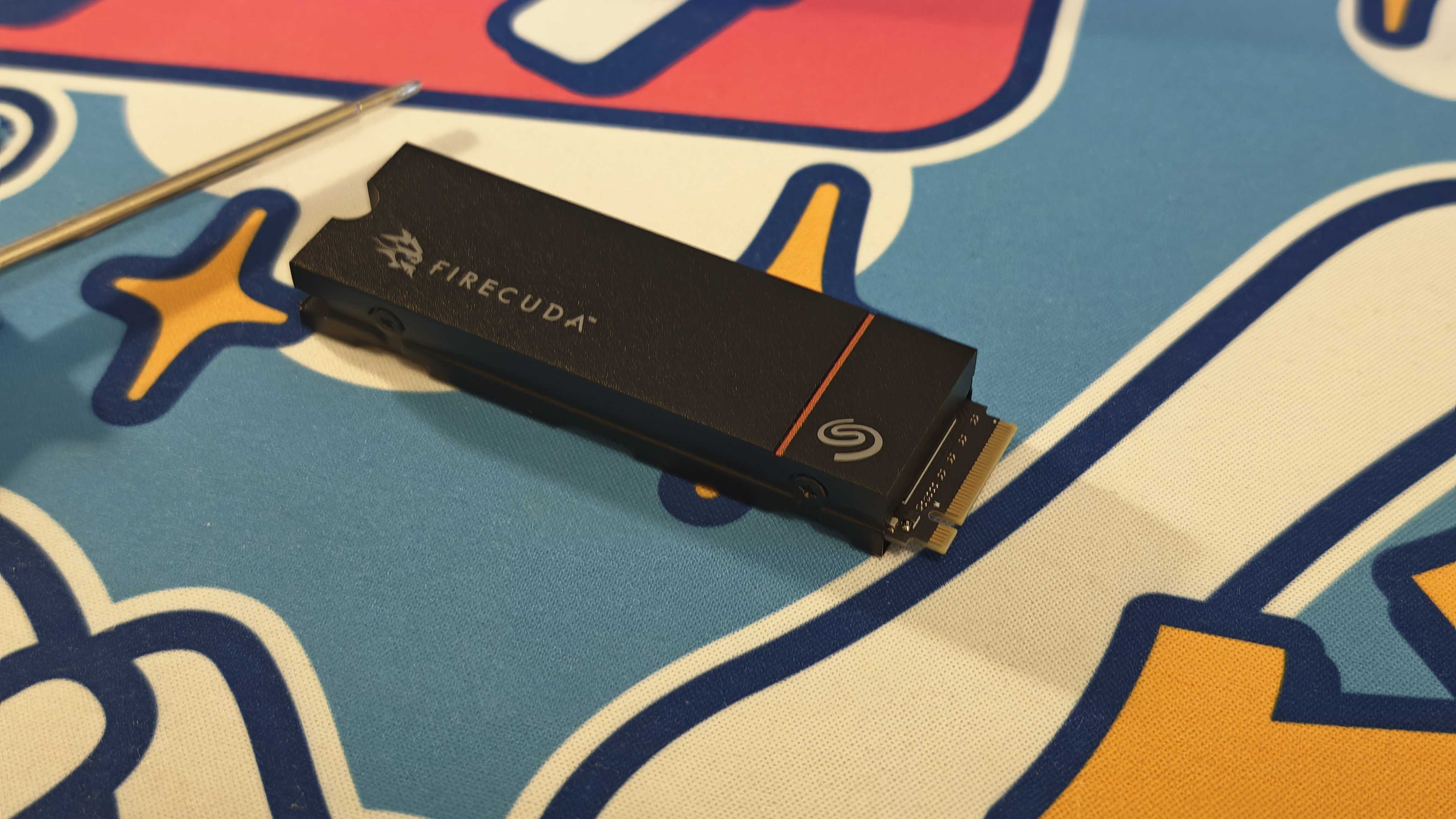 The Seagate FireCuda 530R with heatsink on a colorful fabric desk mat.
