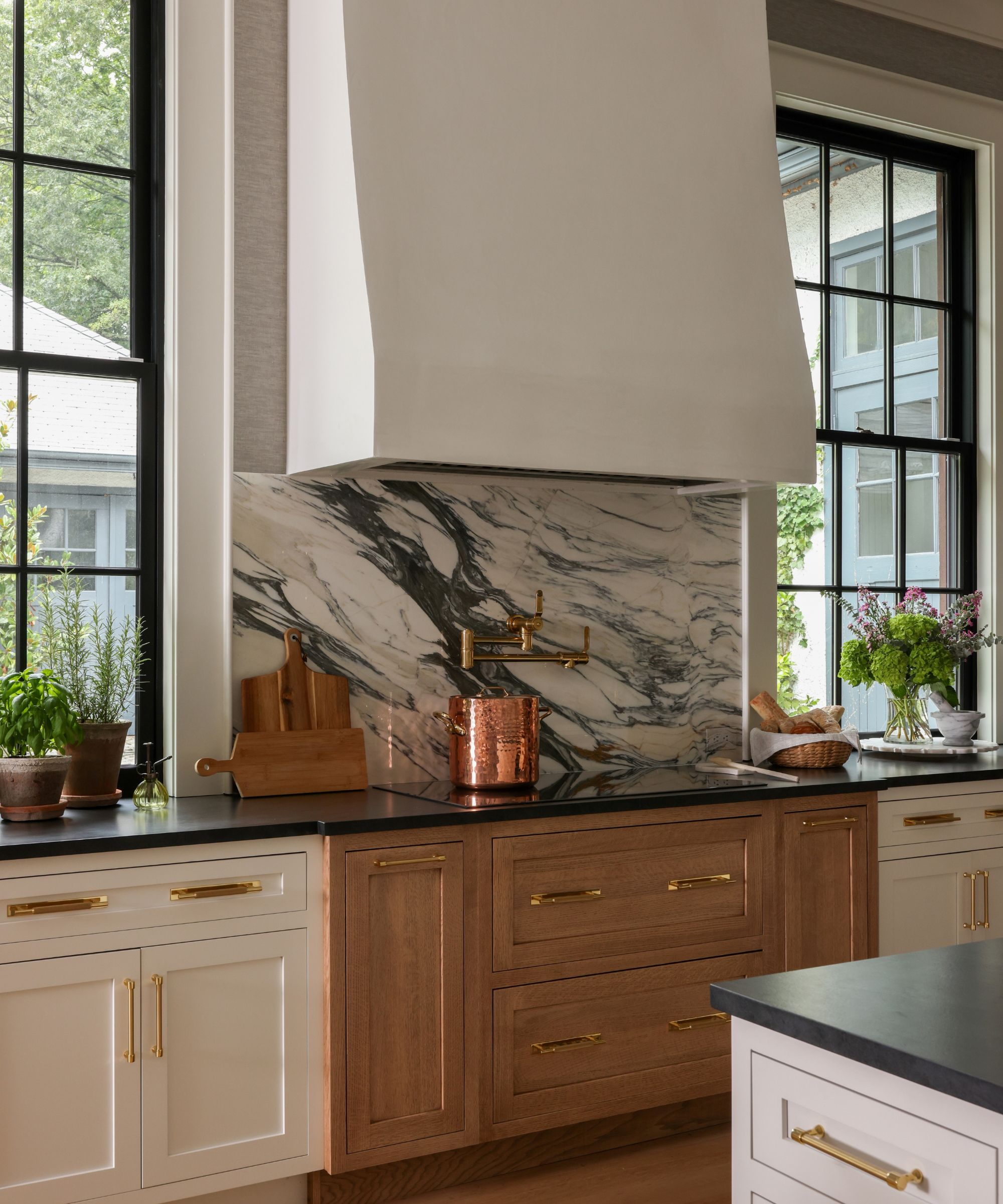 kitchen with hood and marble backsplash