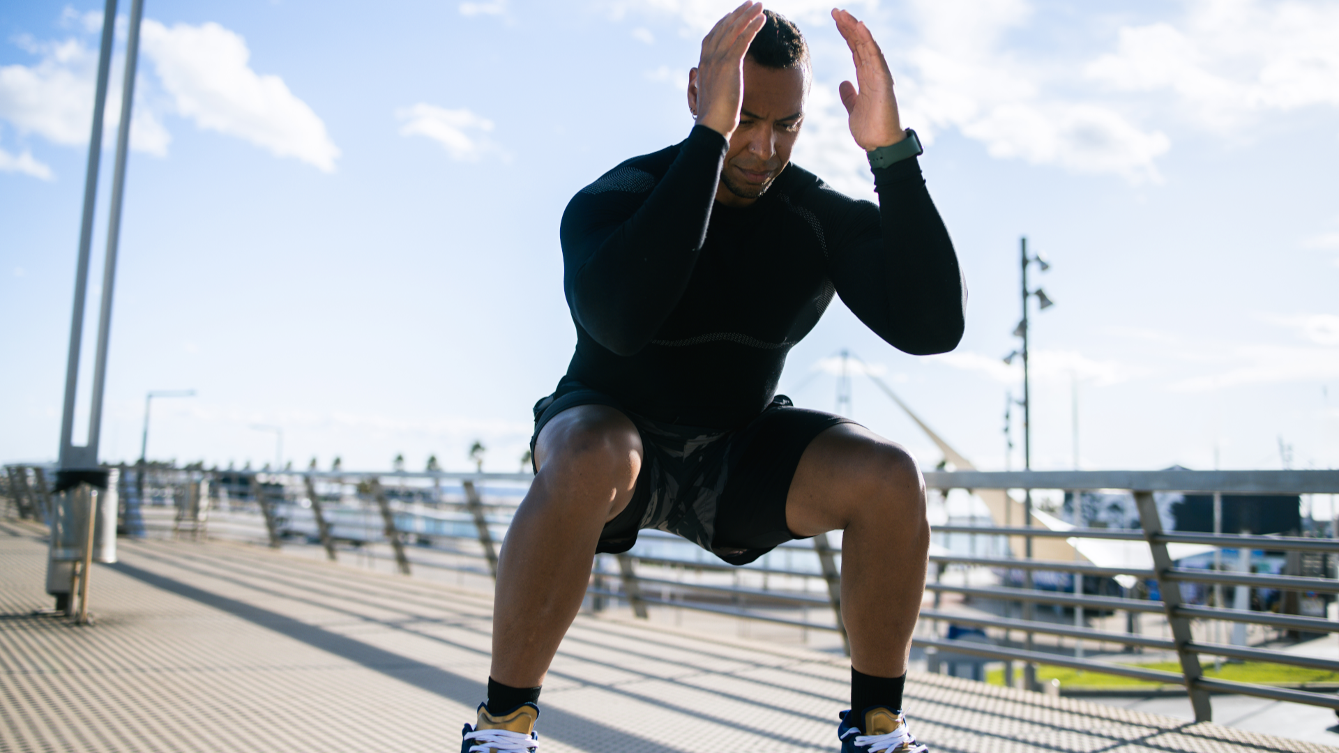 A man doing a squat outdoors