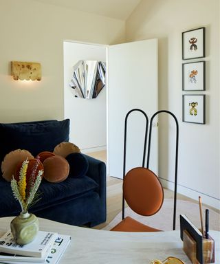 modern space with vintage artwork, wall sconce and a large 3D sculpture hang on the wall