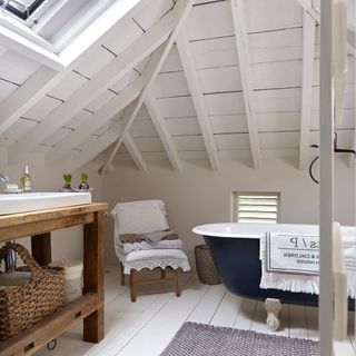 room with wooden flooring and bathtub