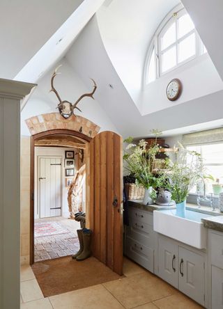 cottage style kitchen with butler sink and wooden door