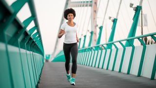 Teen girl exercising on bridge