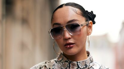 woman wearing glasses and pigtail buns with lipstick on