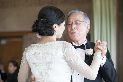 A father dancing with his daughter at her wedding