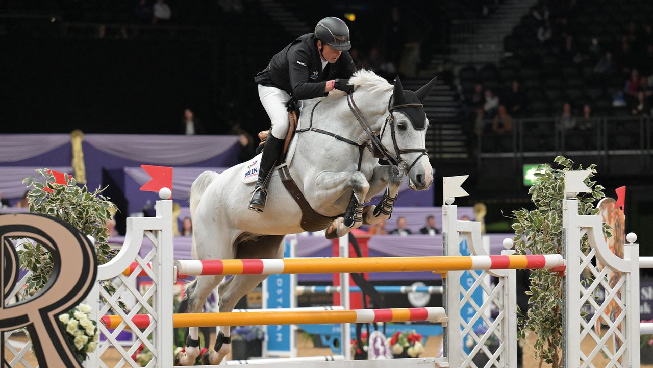 Trevor Breen jumping a grey horse at Horse of the Year Show