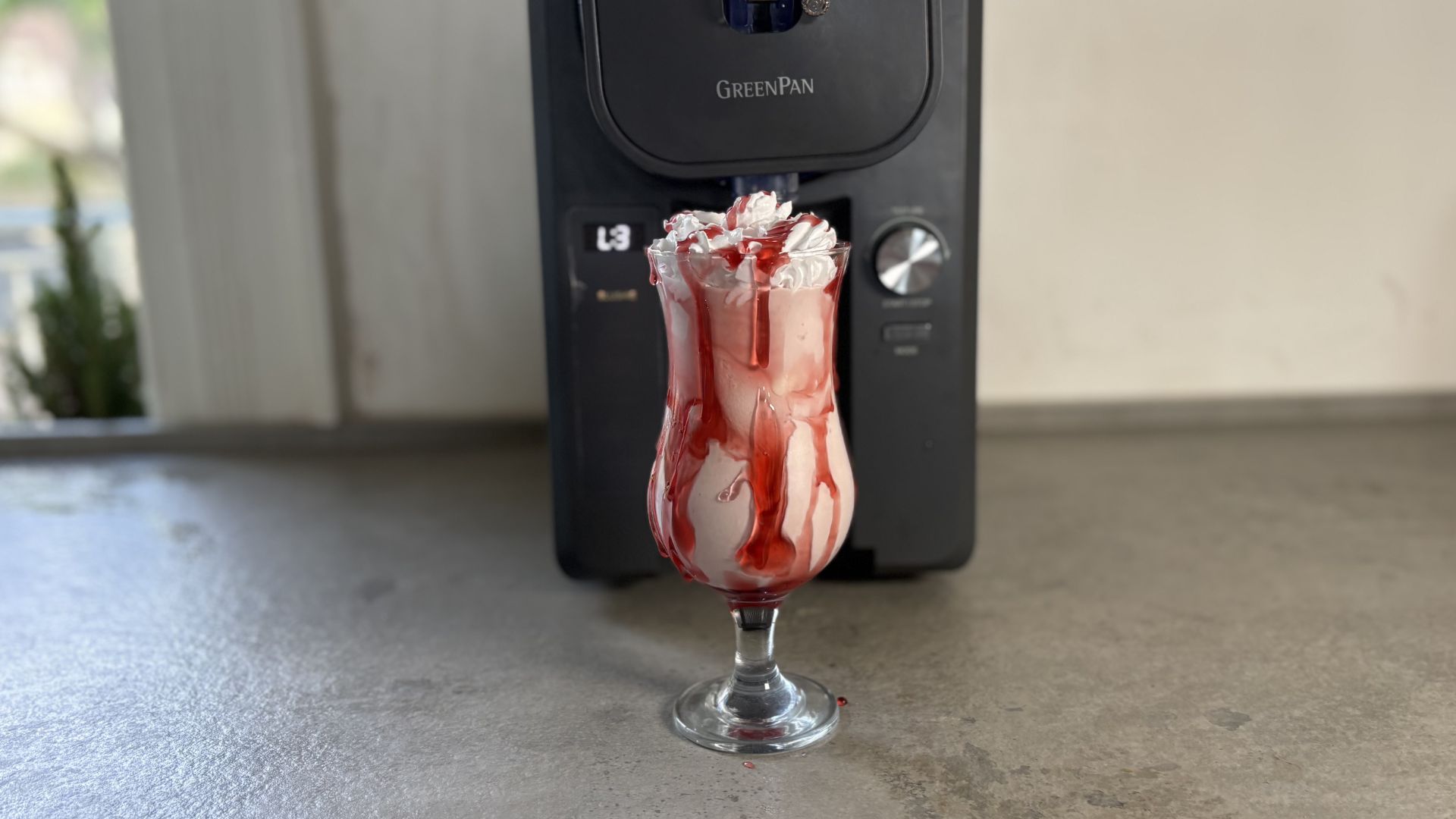 GreenPan Frost Ice Cream Maker and Slushie Machine on the counter having made a milkshake