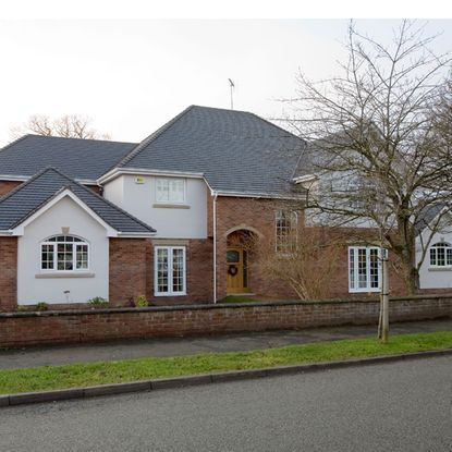 exterior of house with brick walls and road