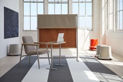 A room divider, lounge chair, desk and stools, part of the ‘Routes’ collection by Pearson Lloyd for Teknion