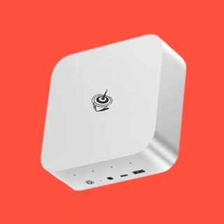 The Beelink SER9 mini PC on a red background