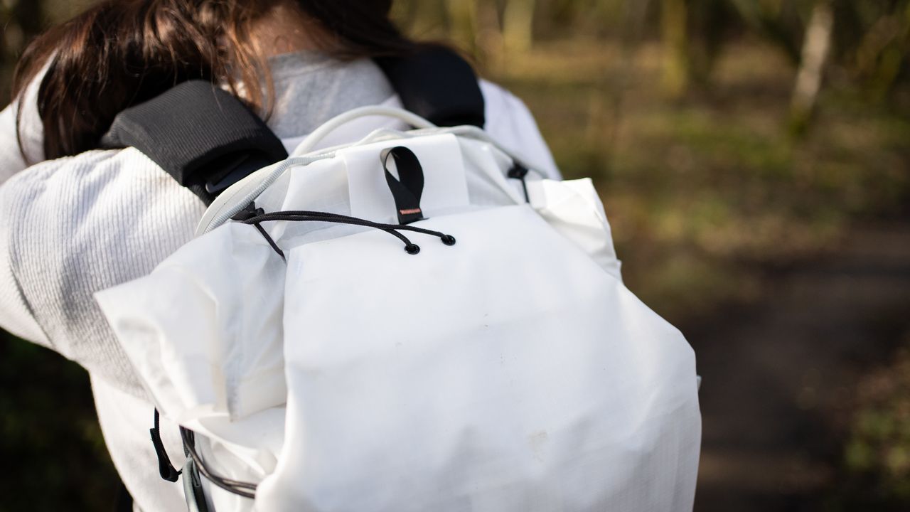woman wearing the peak design outdoor bag in a nature reserve