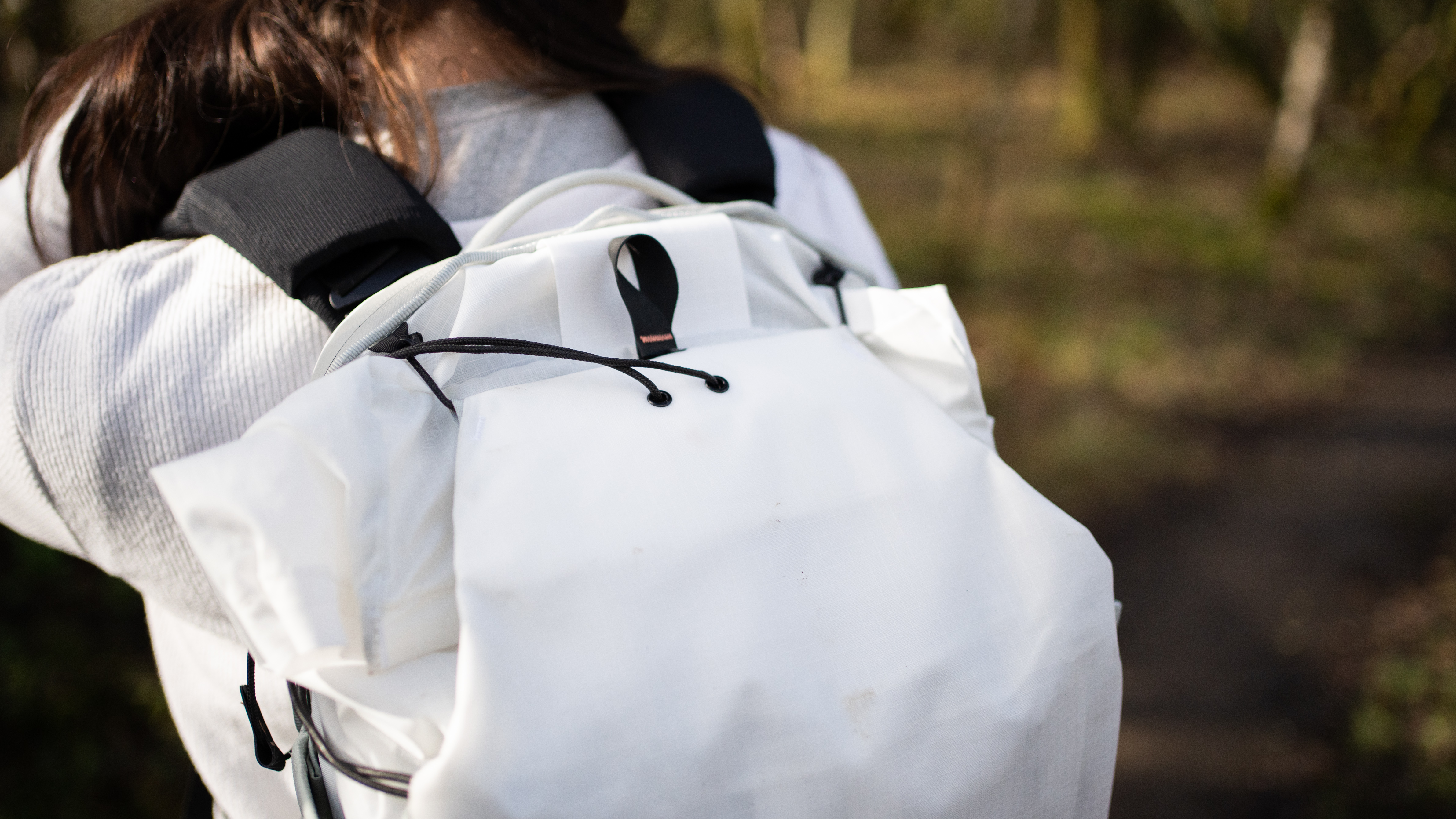 woman wearing the peak design outdoor bag in a nature reserve
