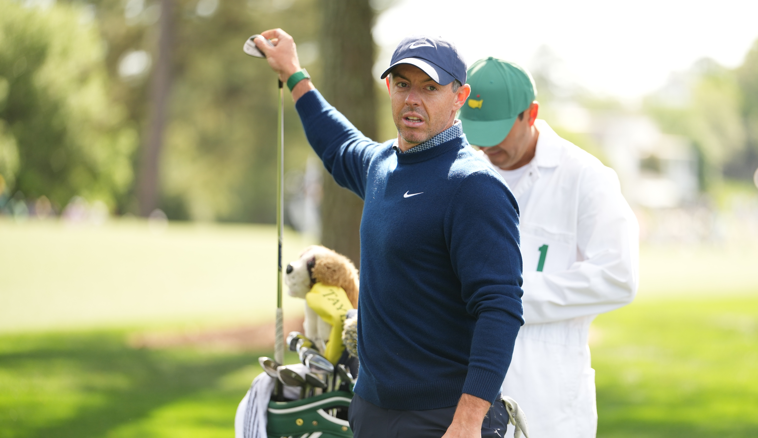 Rory McIlroy takes a club out of his bag