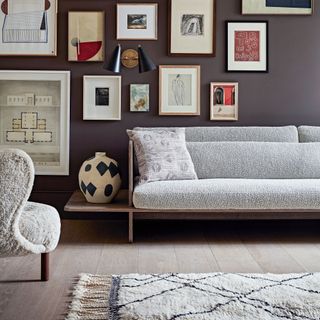 stylish living space with boucle sofa, soft rug and gallery wall