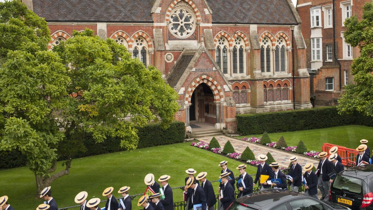 Pupils in straw boaters outside Harrow public school