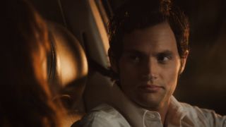 Penn Badgley sitting in the driver's seat of a car in Easy A.