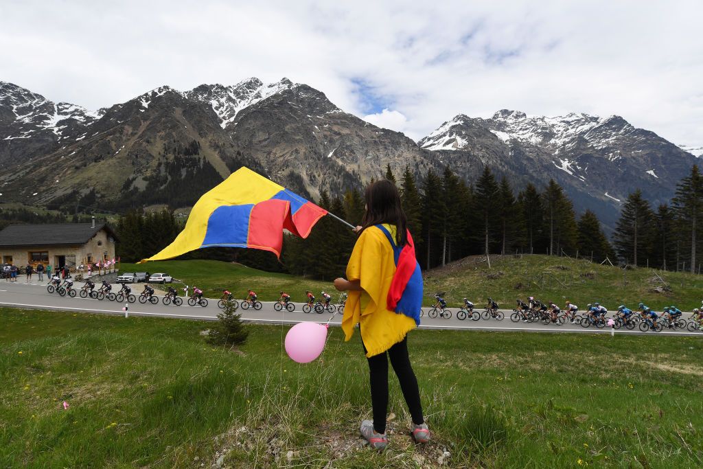 VALLE SPLUGA ALPE MOTTA ITALY MAY 29 Colombian Fans Egan Arley Bernal Gomez of Colombia and Team INEOS Grenadiers Pink Leader Jersey The peloton in Passo San Bernardino 2065m landscape during the 104th Giro dItalia 2021 Stage 20 a 164km stage from Verbania to Valle Spluga Alpe Motta 1727m Switzerland CHE Snow UCIworldtour girodiitalia Giro on May 29 2021 in Valle Spluga Alpe Motta Italy Photo by Tim de WaeleGetty Images