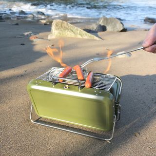 green colour BBQ briefcase on beach