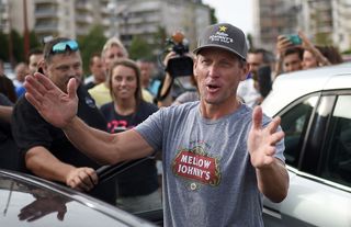 Lance Armstrong talks with fans upon his arrival in Rodez, southwest France, after riding a stage of The Tour De France for a leukaemia charity