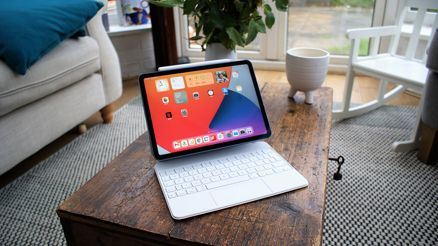 An iPad Air 5 with a Magic Keyboard case sitting on a desk.