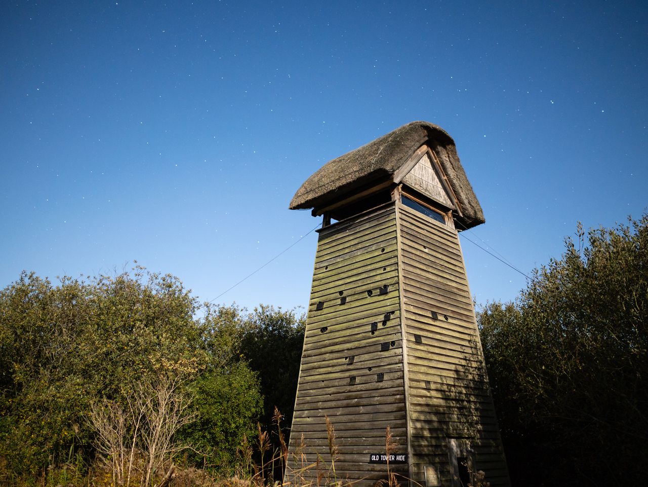 Photo of a lookout tower under the light of a full moon taken with the Panasonic 15mm f1.7 Leica Summilux DG ASPH and Panasonic Lumix GH7.