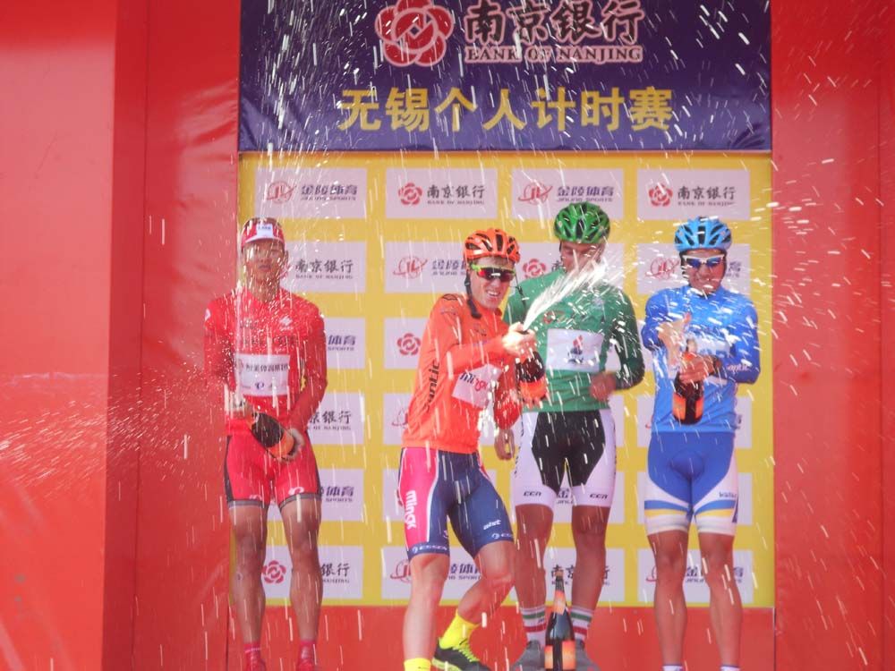 The jersey wearers celebrate on the podium