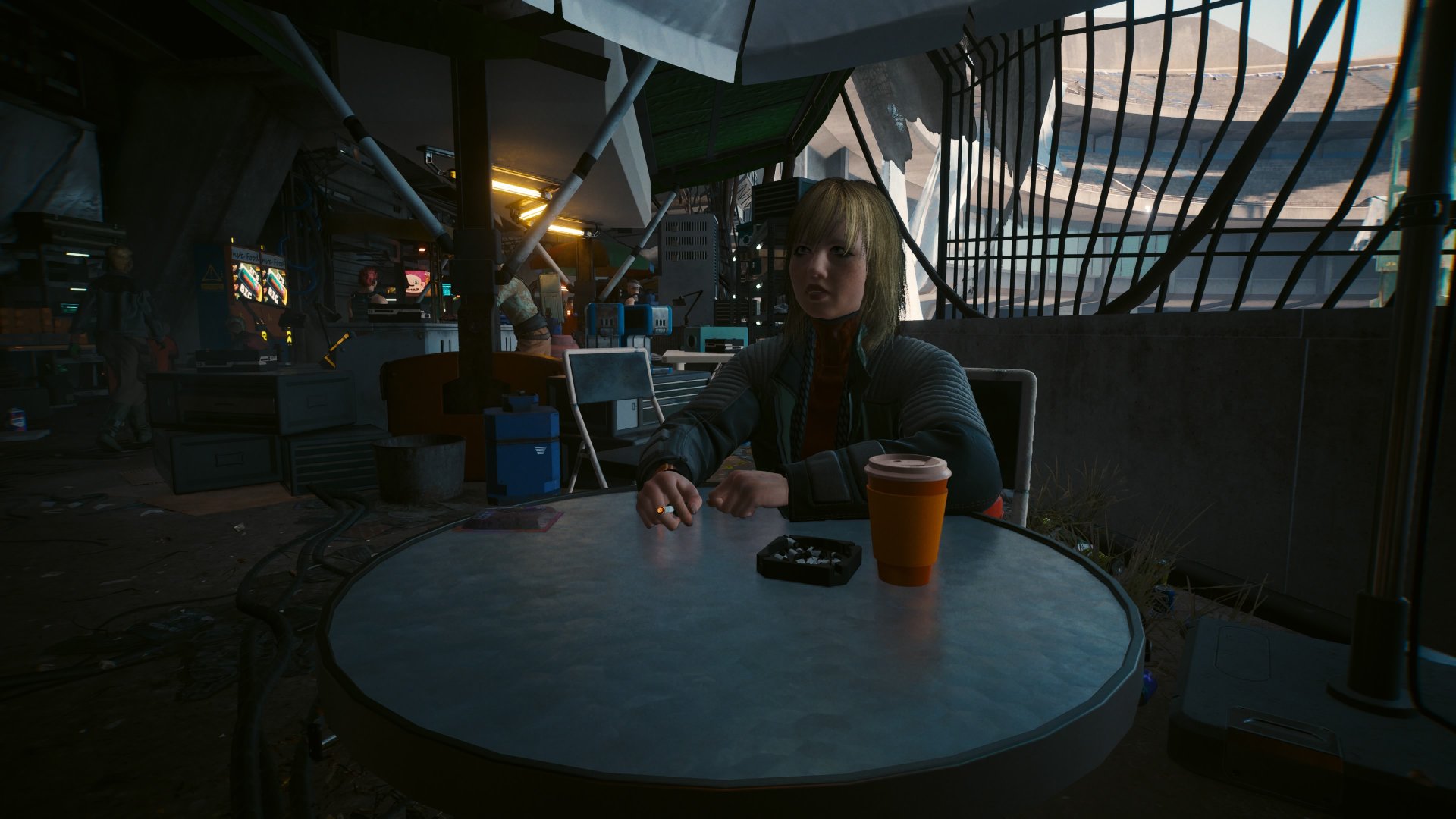 Cyberpunk 2077 Phantom Liberty screenshot of Nele, a young blonde haired woman who sits at a table smoking a cigarette during the gig Road to Redemption