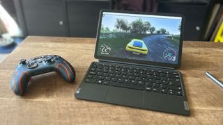 Lenovo Tab P11 Pro Gen 2 tablet streaming Forza Horizon 4 with a controller beside it