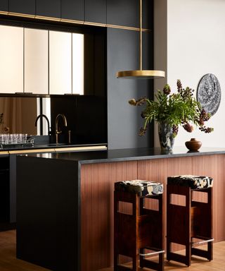 Black and dark wood kitchen with gold accents