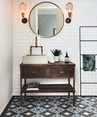 dark wooden washstand with dark geometric floor tiles