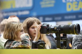 Visitors try out cameras on Nikon stand at TPS2018