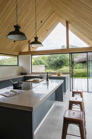 Timber clad vaulted ceilings in extension to listed cottage