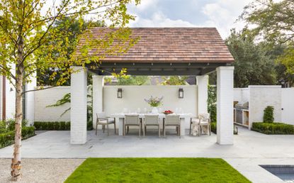 Freestanding shade structure in a modern Spanish-style backyard 